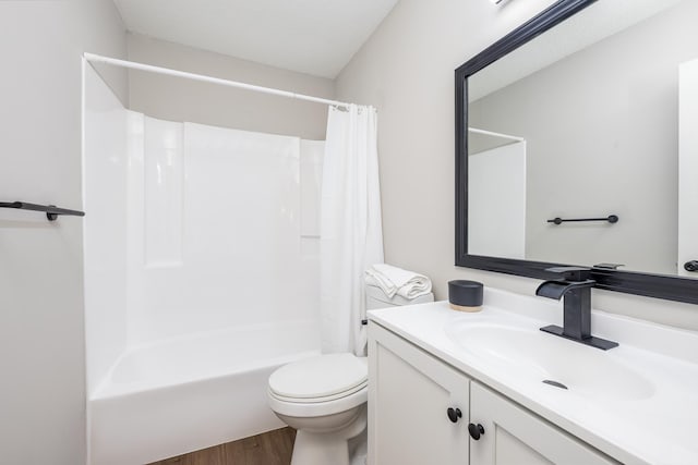 bathroom with shower / tub combo with curtain, toilet, vanity, and wood finished floors