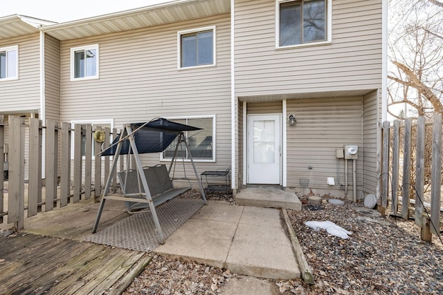 rear view of property featuring a patio and fence