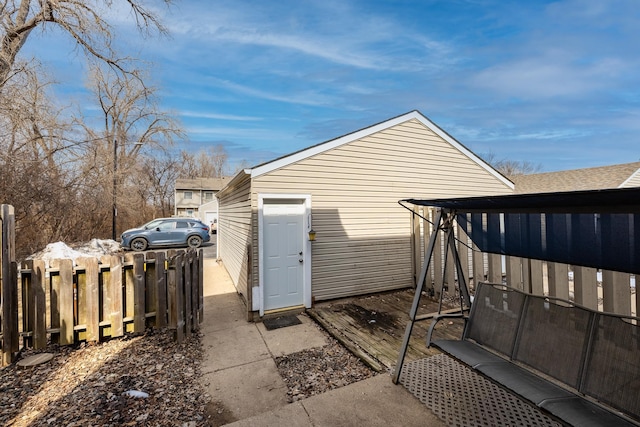 view of outbuilding with fence