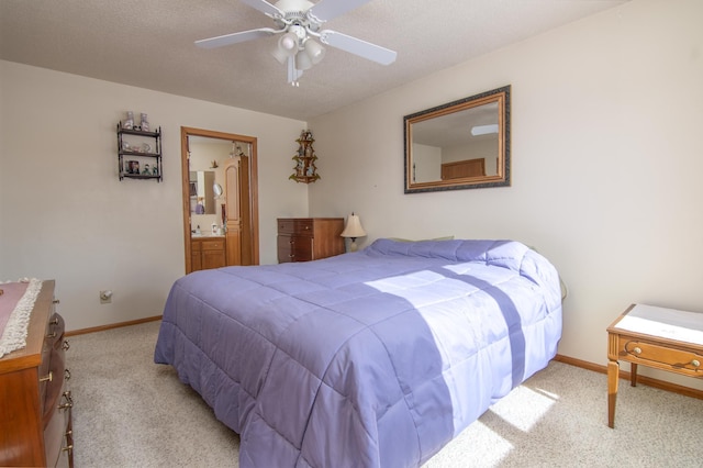 carpeted bedroom with ceiling fan, baseboards, a textured ceiling, and ensuite bathroom