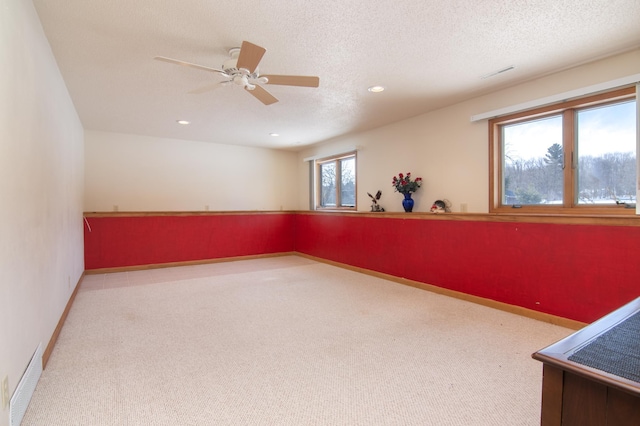 carpeted empty room with recessed lighting, visible vents, a textured ceiling, and baseboards