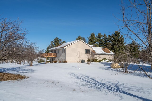 view of snow covered exterior with a wooden deck