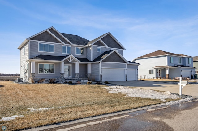 view of front of home featuring driveway, central air condition unit, and a front yard