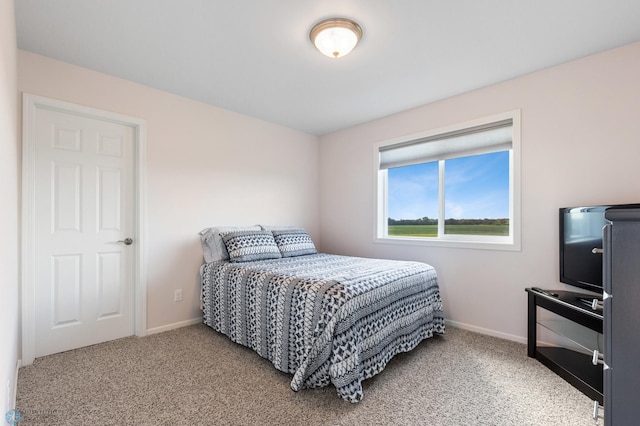 bedroom with light carpet and baseboards