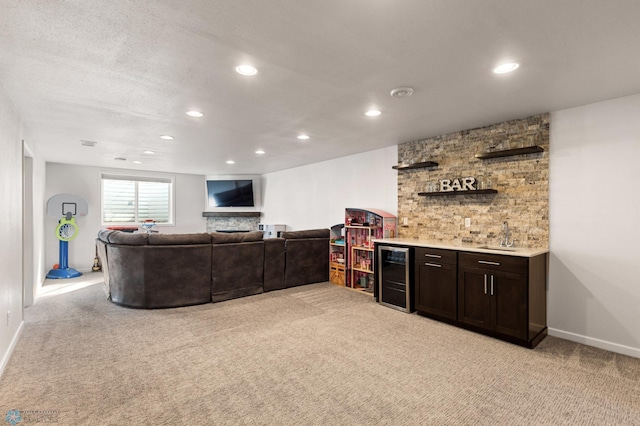 living room featuring light carpet, beverage cooler, baseboards, wet bar, and recessed lighting