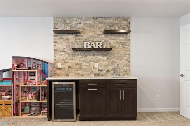 bar featuring baseboards, light colored carpet, wine cooler, wet bar, and a sink