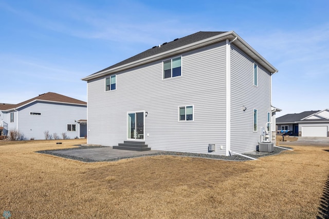 back of house featuring entry steps, a yard, central AC, and a patio area