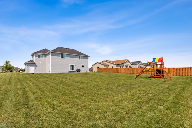 view of yard with fence and a playground