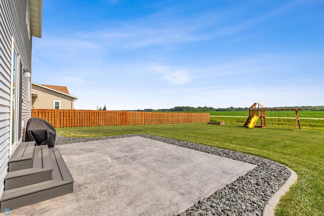 view of patio featuring a playground and fence