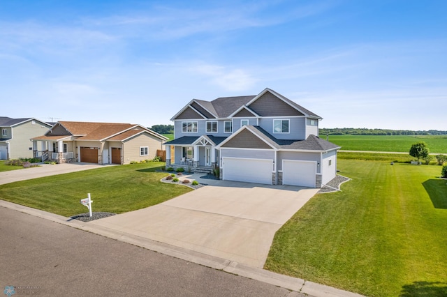 craftsman-style home featuring a garage, concrete driveway, and a front yard