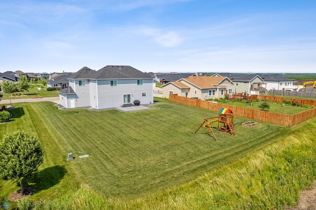 exterior space with a residential view, a yard, and fence private yard