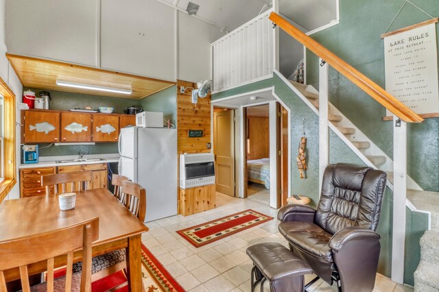 47166 Franklin Ct, Dunn Twp, MN 56572 - dining area with light tile patterned floors, heating unit, a towering ceiling, and stairs