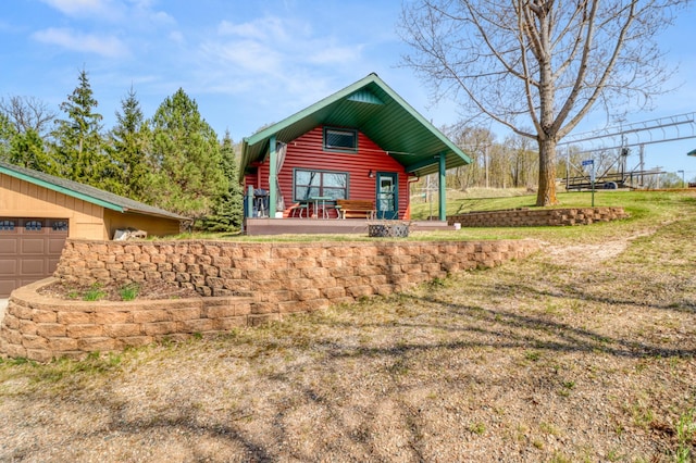 47166 Franklin Ct, Dunn Twp, MN 56572 - view of front of property featuring a porch, a garage, log veneer siding, and a front yard