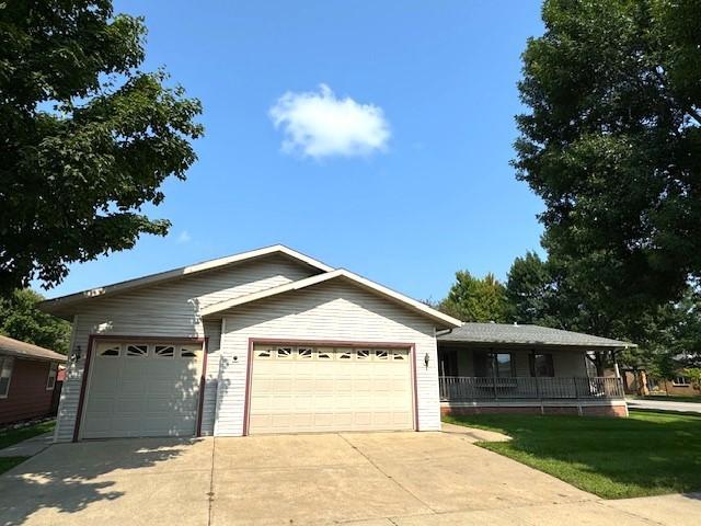 single story home with a garage, driveway, and covered porch