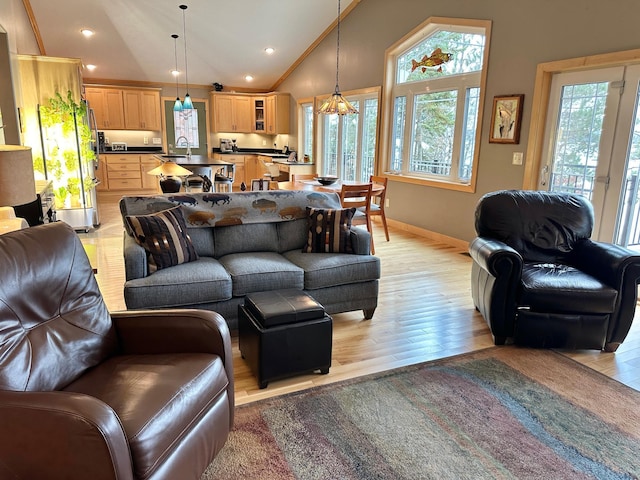 living area with light wood-type flooring, a wealth of natural light, baseboards, and recessed lighting