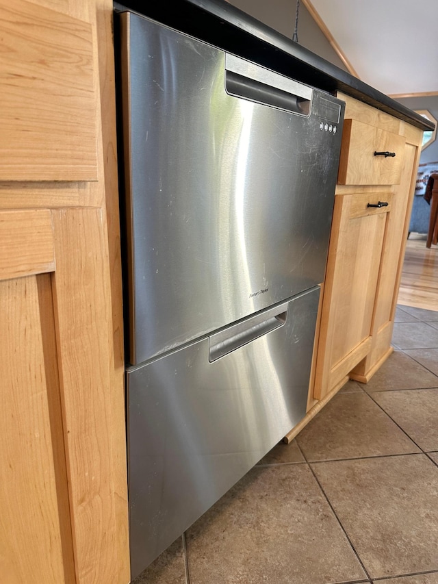 room details with light brown cabinetry and fridge