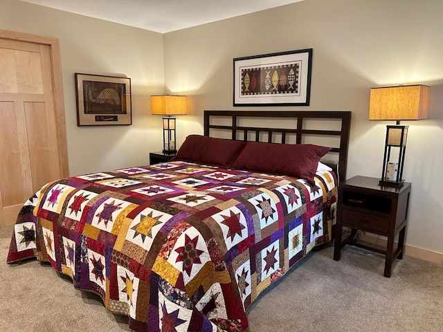 carpeted bedroom with baseboards