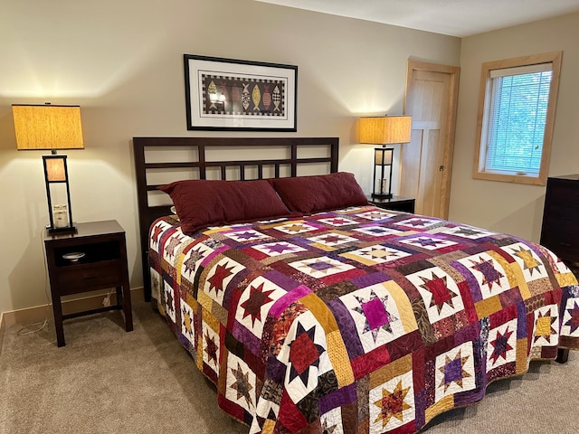 carpeted bedroom featuring baseboards