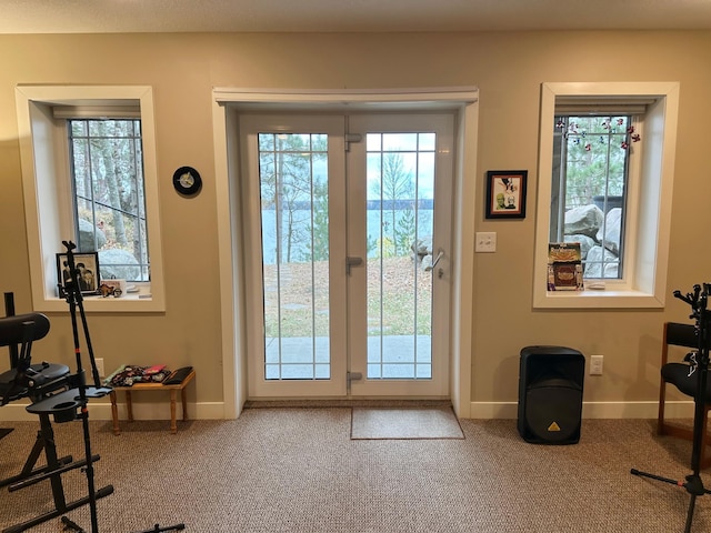 entryway with carpet and baseboards