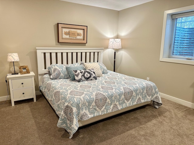 carpeted bedroom featuring baseboards