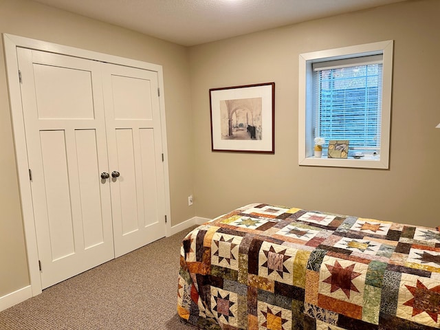 bedroom featuring carpet and baseboards