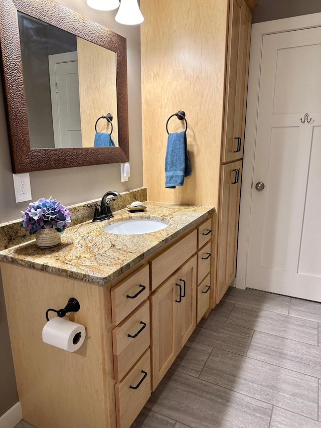 bathroom featuring wood finished floors and vanity