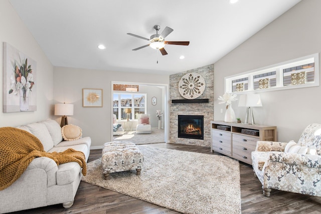 living area featuring dark wood-type flooring, recessed lighting, a stone fireplace, ceiling fan, and vaulted ceiling