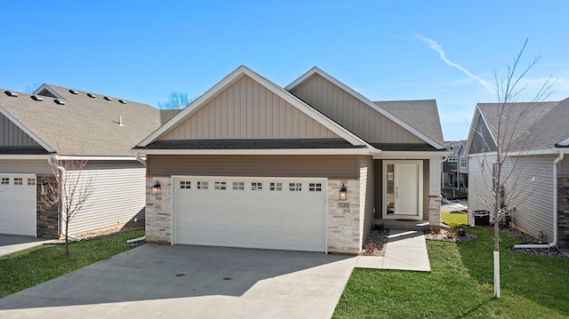 view of front facade featuring a front yard, an attached garage, driveway, and a shingled roof