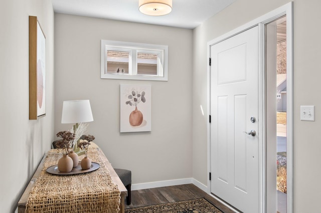 entrance foyer featuring dark wood finished floors and baseboards