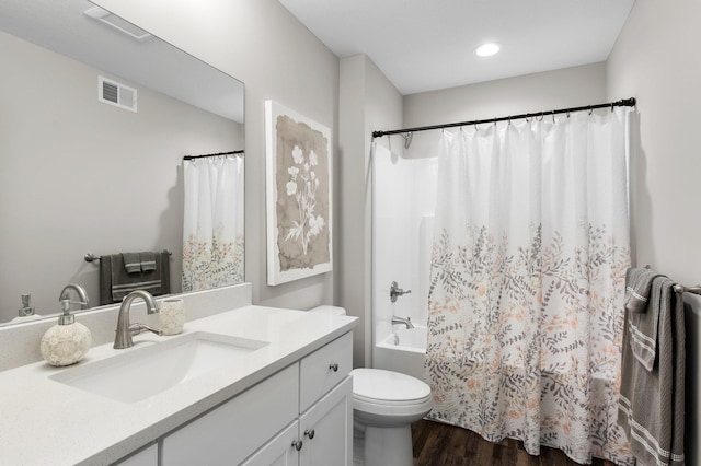 full bathroom with visible vents, shower / bathtub combination with curtain, toilet, wood finished floors, and vanity