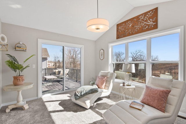 sitting room with lofted ceiling, plenty of natural light, carpet, and baseboards