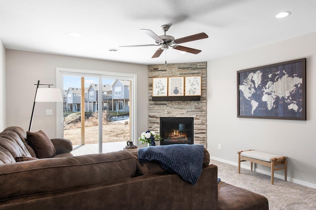 carpeted living area featuring visible vents, a ceiling fan, recessed lighting, a stone fireplace, and baseboards