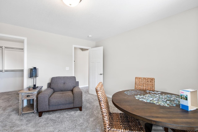 dining space with baseboards and carpet floors