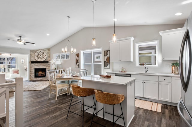 1125 Hewitt Blvd, Red Wing, MN 55066 - kitchen featuring a sink, a fireplace, white cabinets, a kitchen island, and light countertops