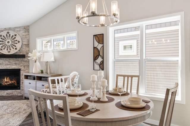 1125 Hewitt Blvd, Red Wing, MN 55066 - dining space with vaulted ceiling, a chandelier, a fireplace, and wood finished floors