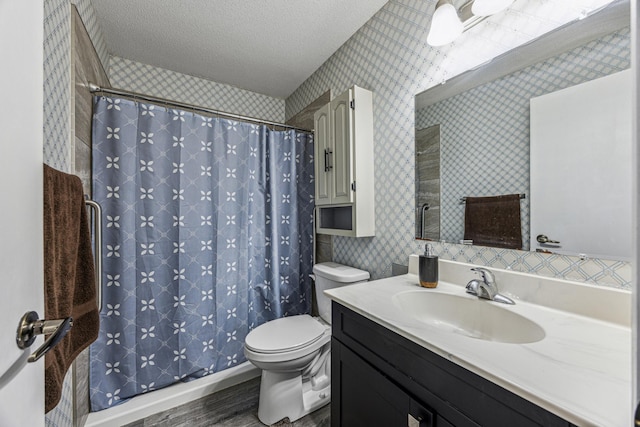 full bath with toilet, wallpapered walls, a textured ceiling, and vanity