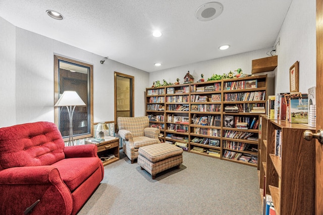 living area with a textured ceiling, carpet flooring, and recessed lighting