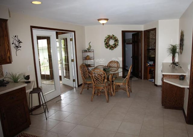 dining room with light tile patterned flooring and french doors