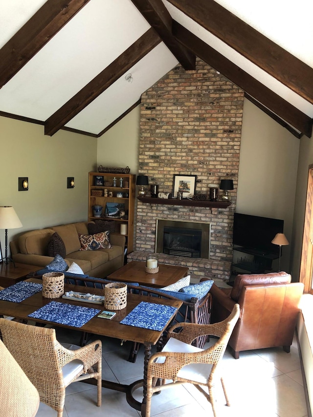 living room with tile patterned floors, a brick fireplace, and vaulted ceiling with beams