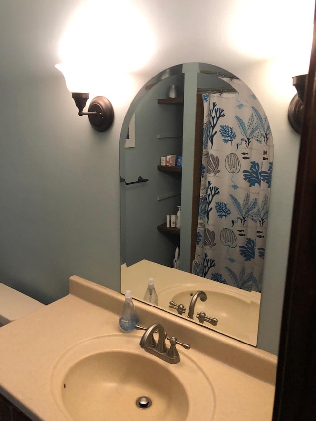 bathroom featuring curtained shower and vanity