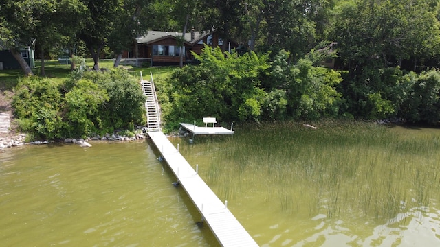 view of dock featuring a water view and stairs