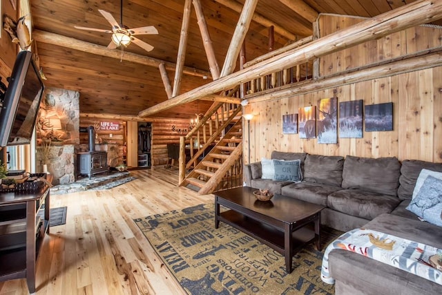 living room with wooden ceiling, stairway, hardwood / wood-style flooring, and beamed ceiling