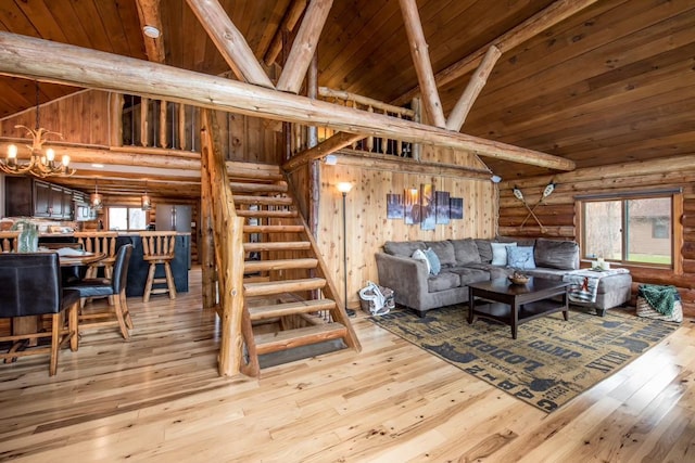 living room featuring wood ceiling, stairs, hardwood / wood-style floors, beamed ceiling, and an inviting chandelier