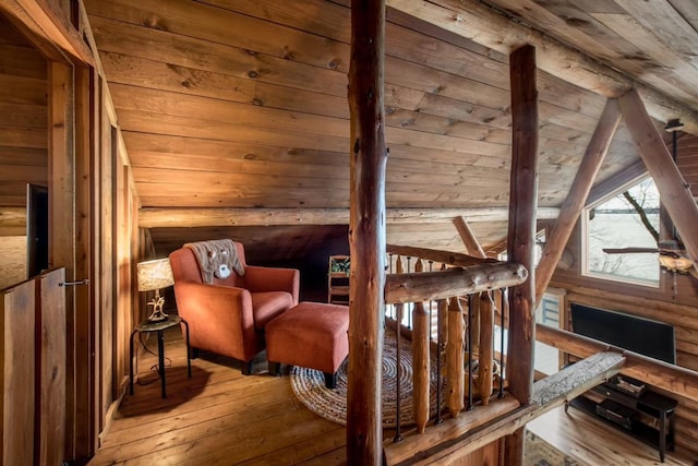 living area with vaulted ceiling with beams, wood ceiling, and hardwood / wood-style flooring