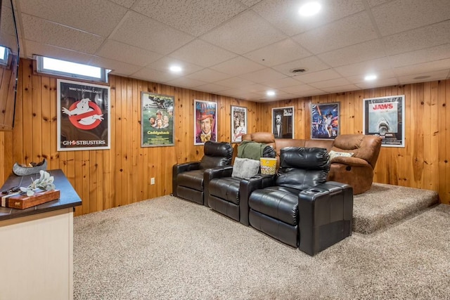 cinema featuring wood walls and carpet