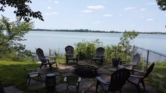 view of patio featuring a fire pit and a water view