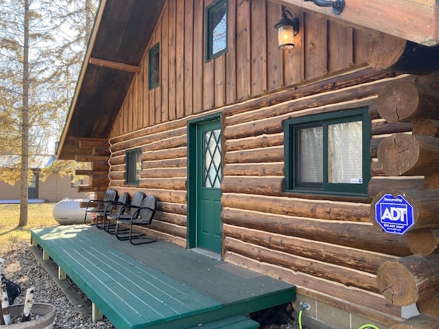 view of home's exterior with board and batten siding and log siding