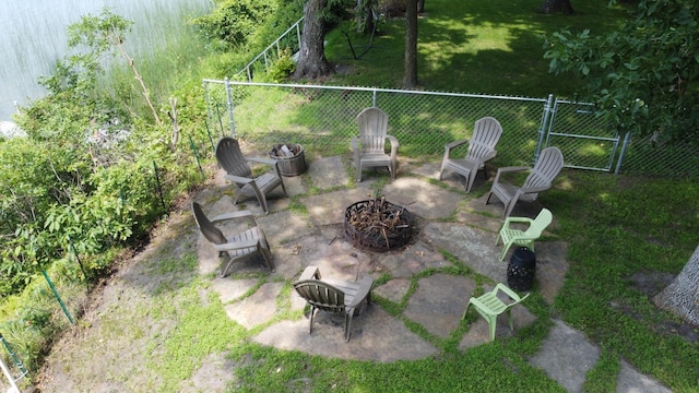 view of yard featuring an outdoor fire pit, a patio, and fence