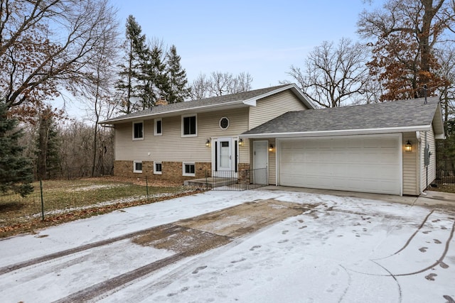 view of front of property with roof with shingles, a garage, driveway, and a chimney