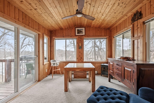 sunroom featuring wooden ceiling, a ceiling fan, and lofted ceiling